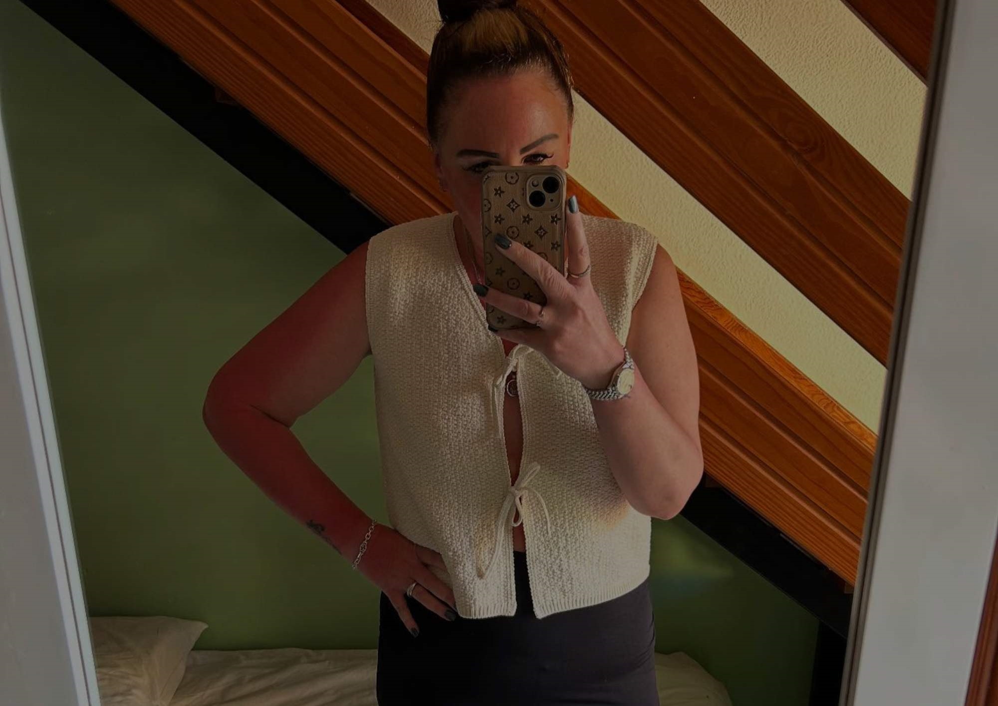 Girl taking a mirror selfie in a white top Girl taking a mirror selfie in a white top